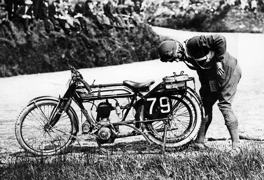 Norman Black repairing a puncture on his Norton bike, 1920