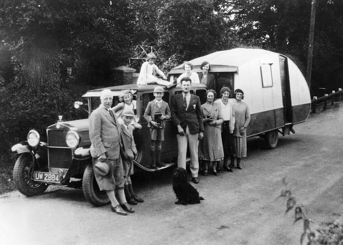 Family group with their 1930 Fiat towing a caravan