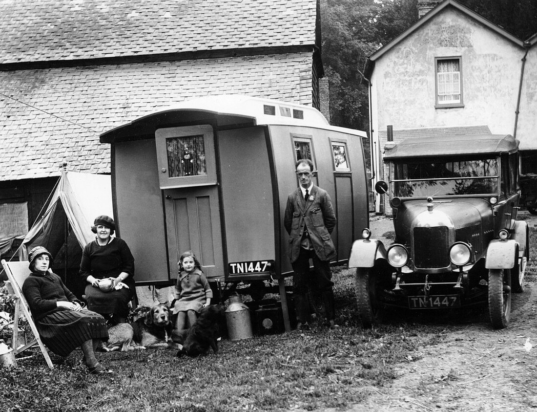 Family group with a 1925 Morris Oxford 14 28 and caravan