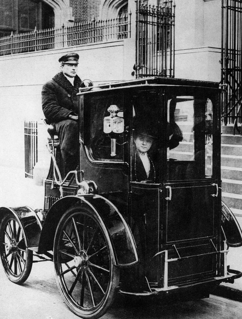 Woman passenger in a 1910 taxi cab, New York, USA