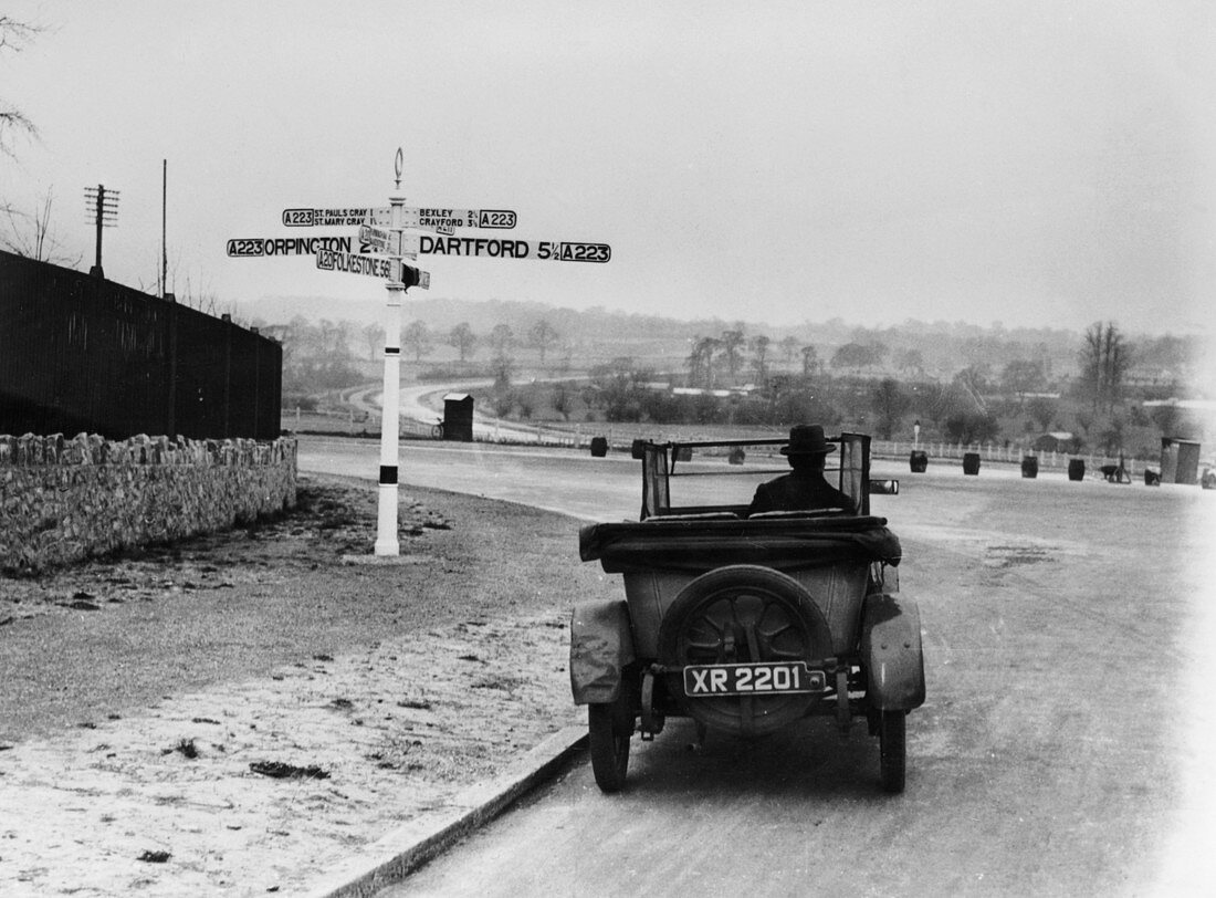 Car near a road sign, Bromley, Kent, 1920s