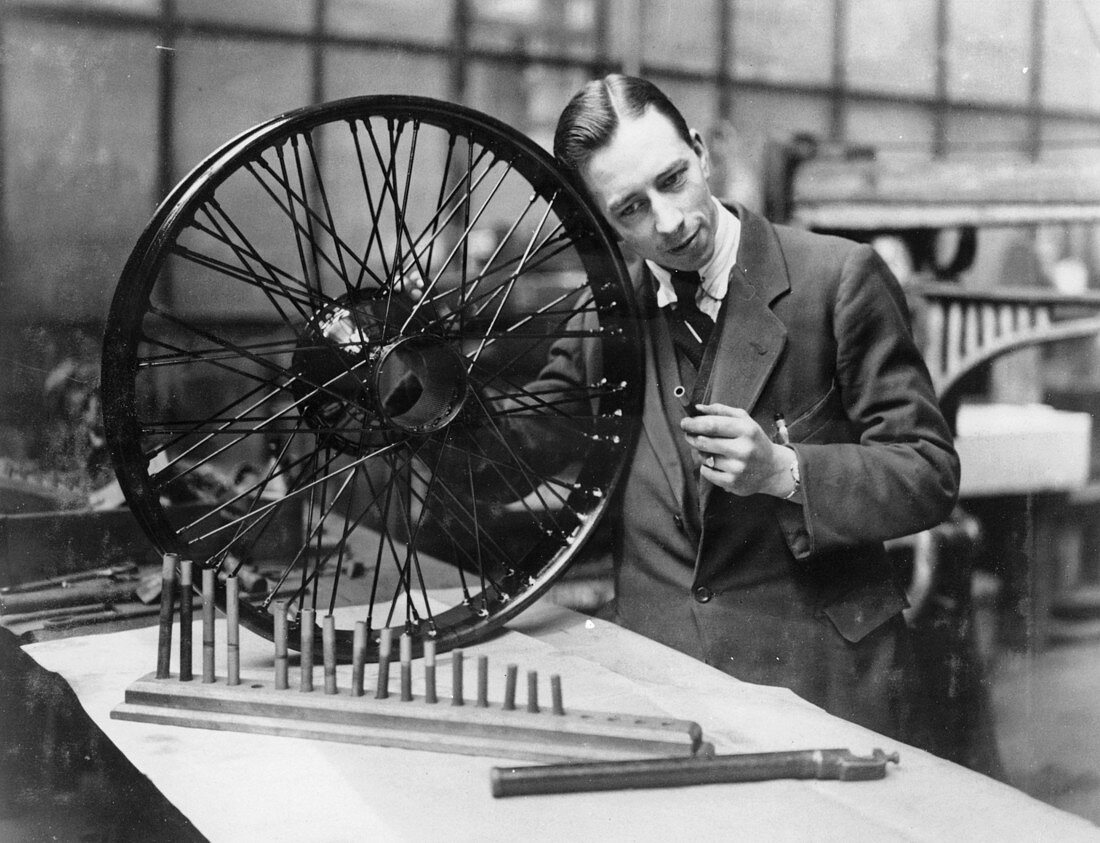A man in a workshop with a wheel