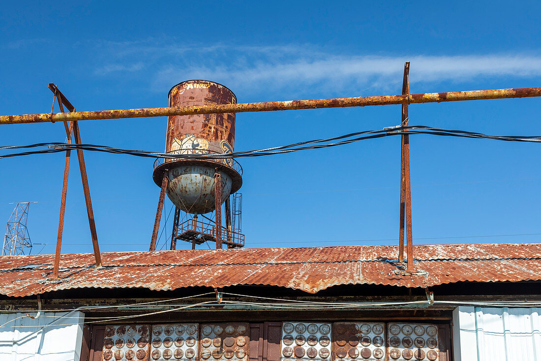 Rusting water tower and warehouse