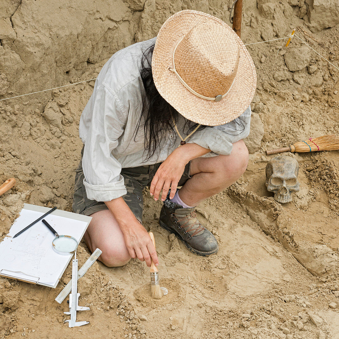 Archaeologist excavating a coin