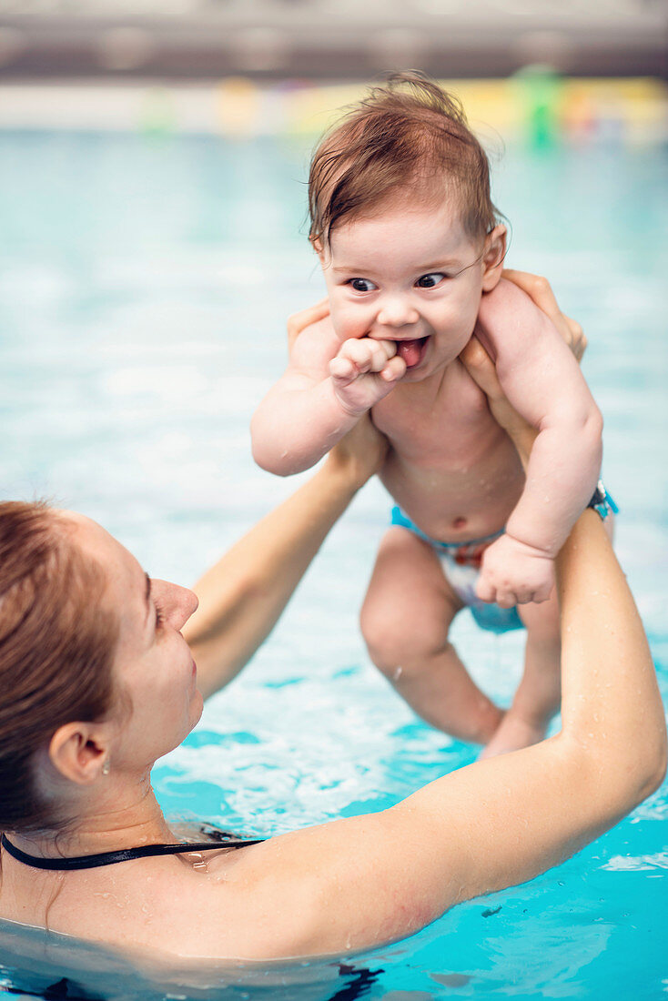 Baby with mother in swimming pool