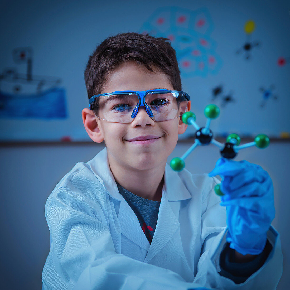 Schoolboy holding molecular model