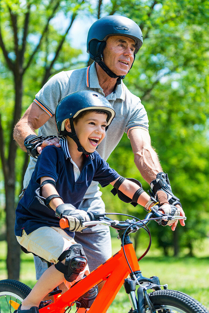 Grandfather and grandson having fun in the park