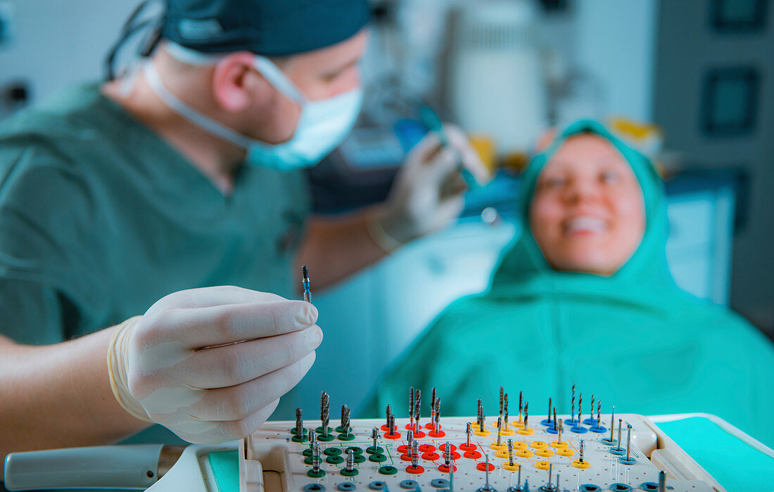 Dentist installing dental implant