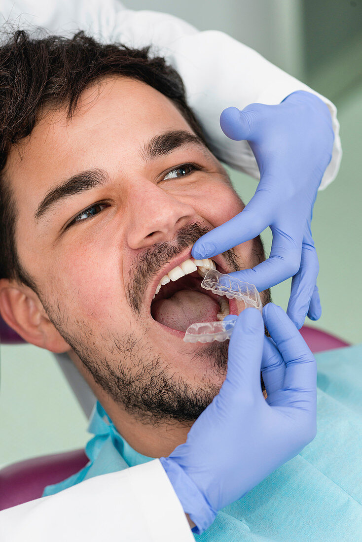 Orthodontist fitting invisible braces