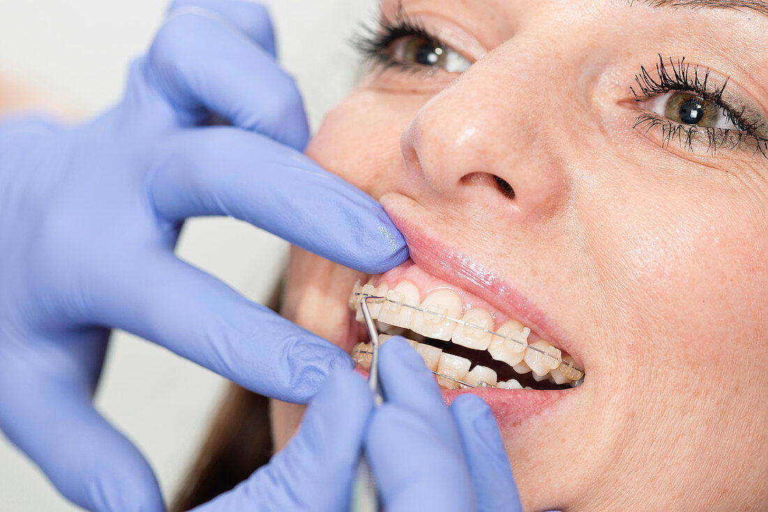 Orthodontist tightening braces