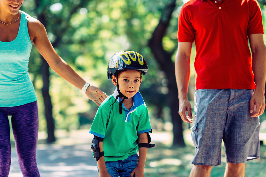 Family roller skating in park