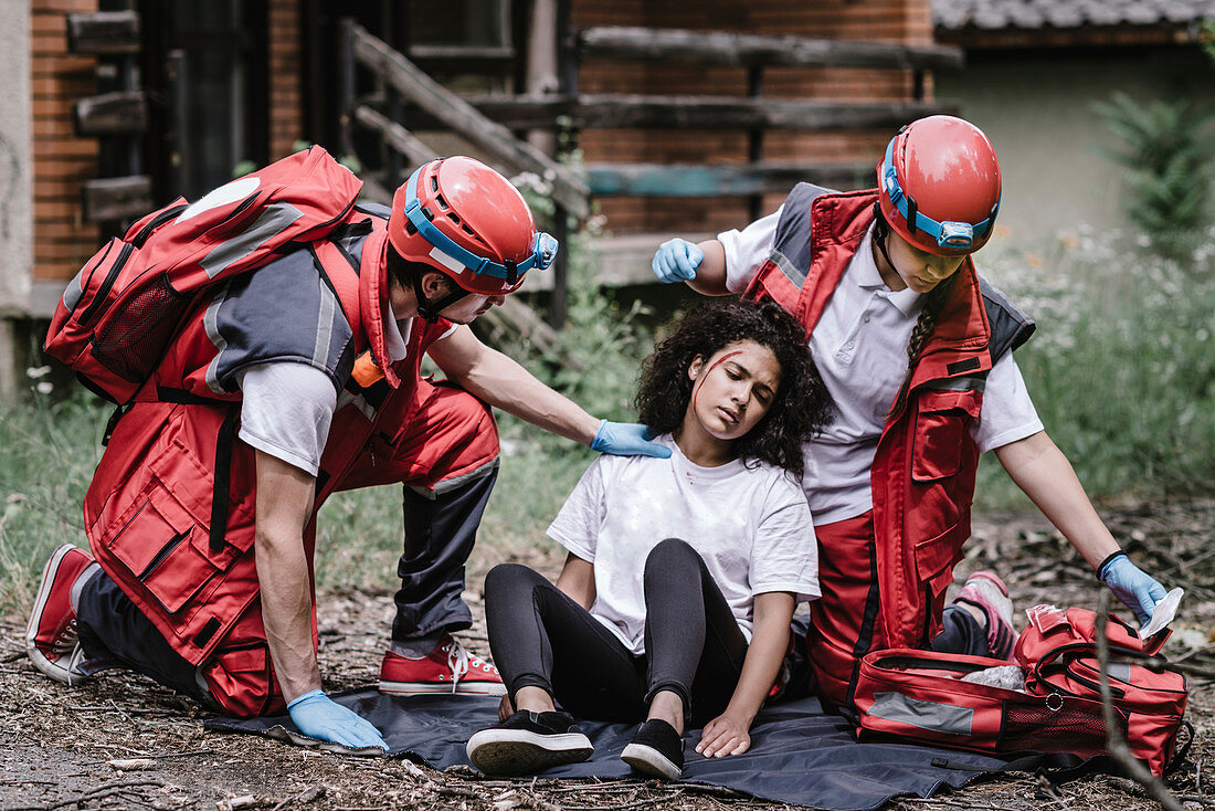 Rescue team helping injured woman