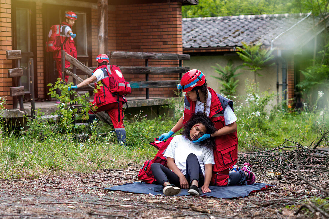 Rescue team helping injured woman