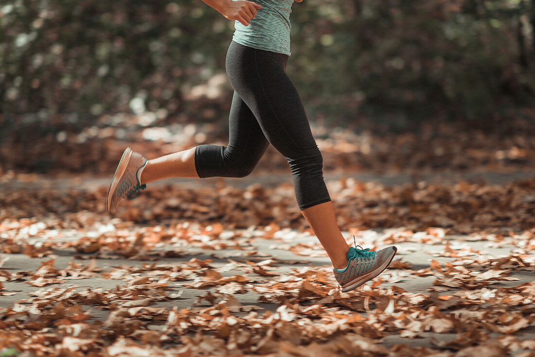 Woman jogging outdoors in autumn