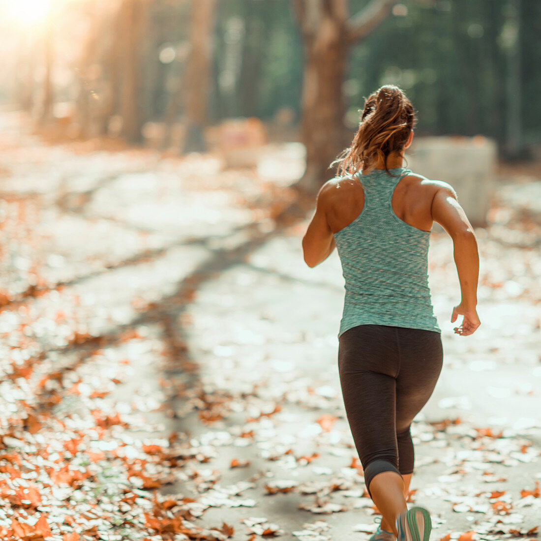 Woman jogging outdoors in autumn