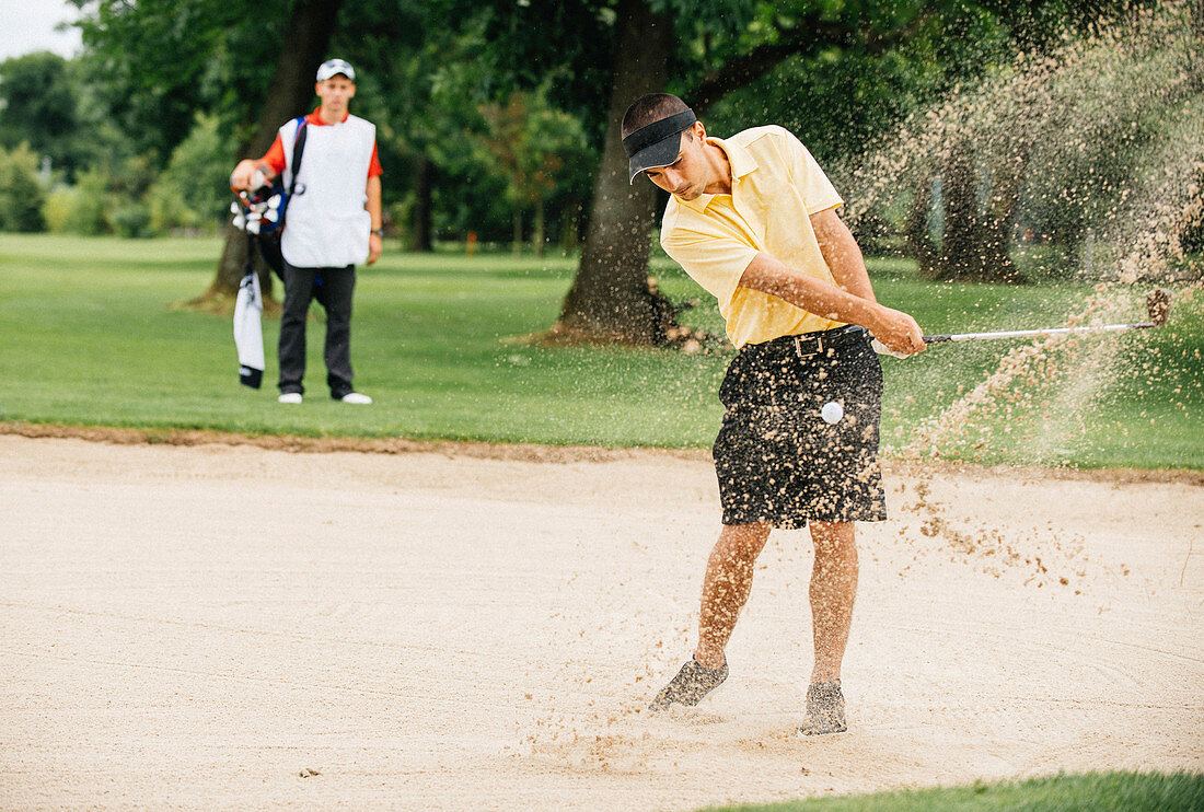 Golfer playing from sand trap