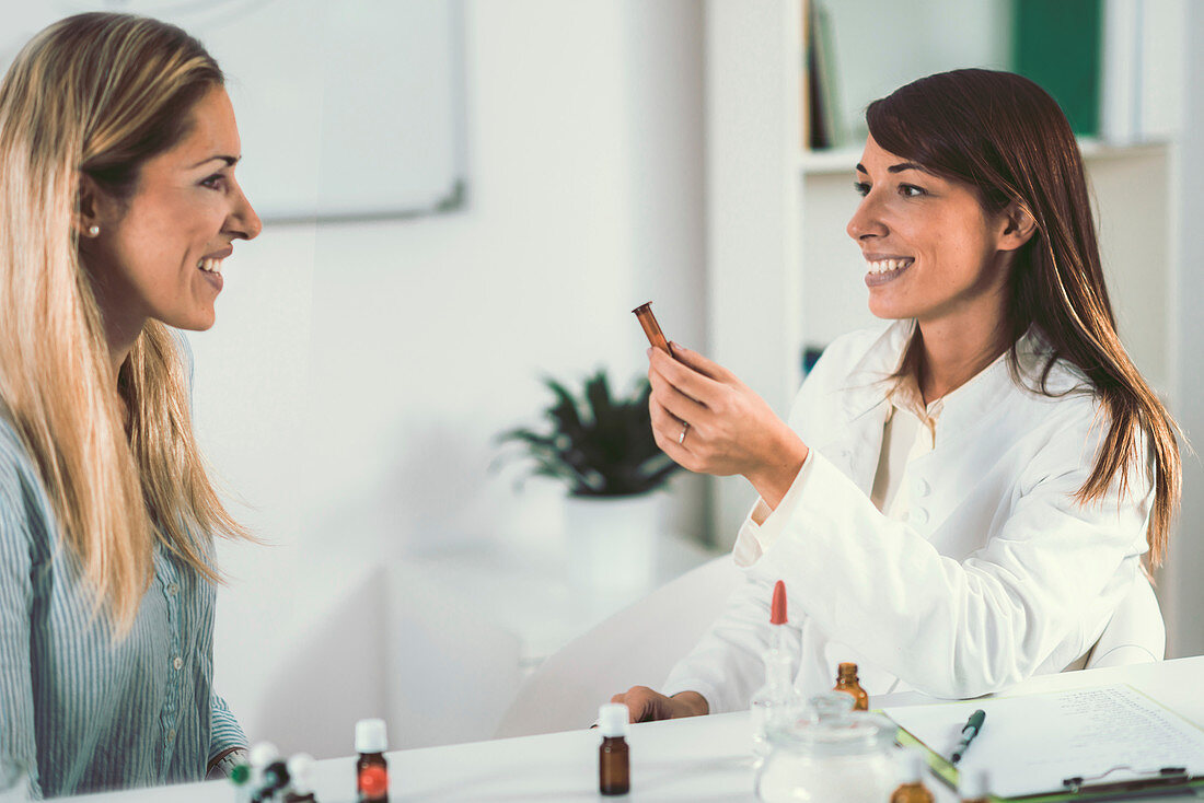 Homeopath giving remedy to woman