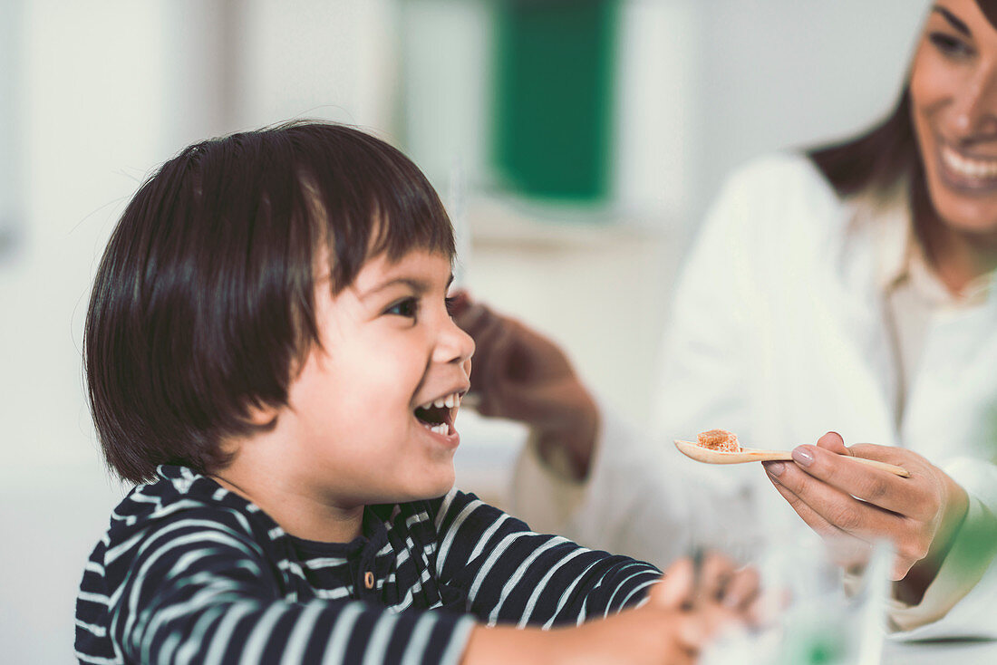 Homeopath giving remedy to child