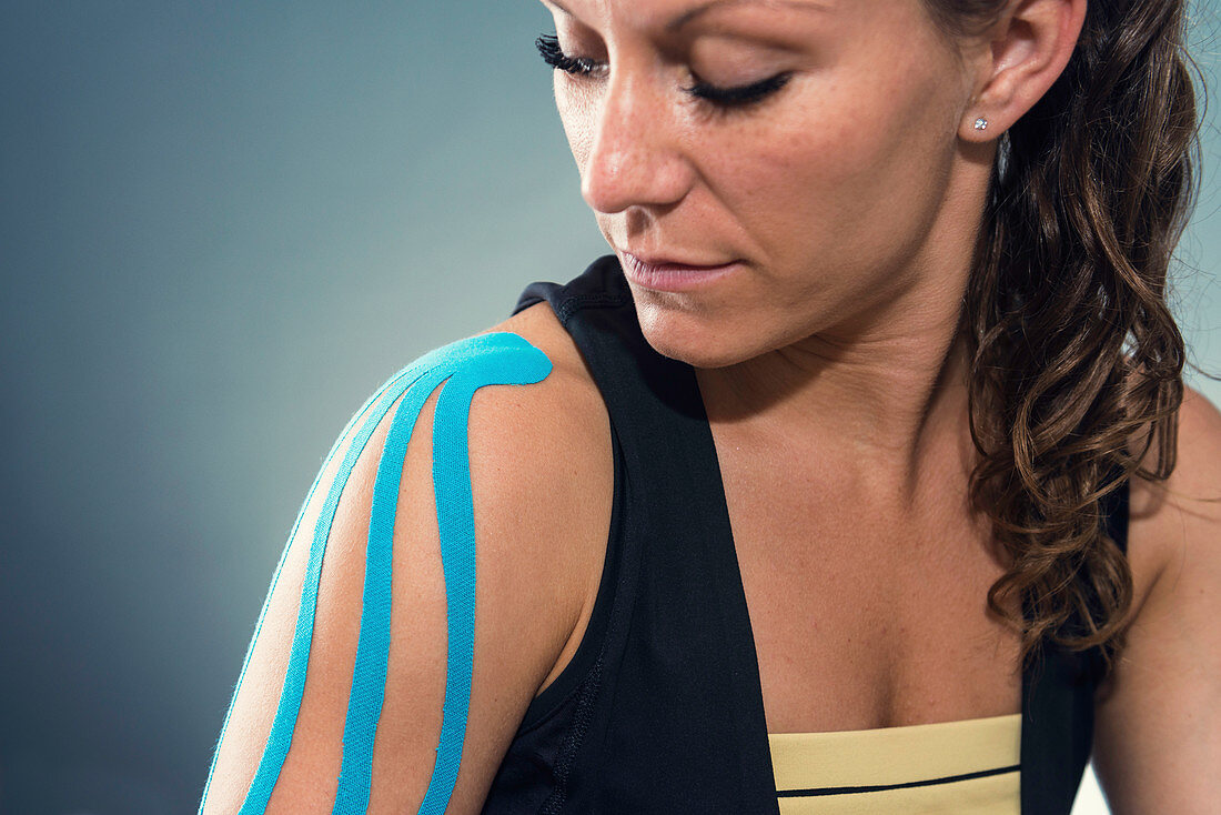 Woman with kinesiotape on shoulder