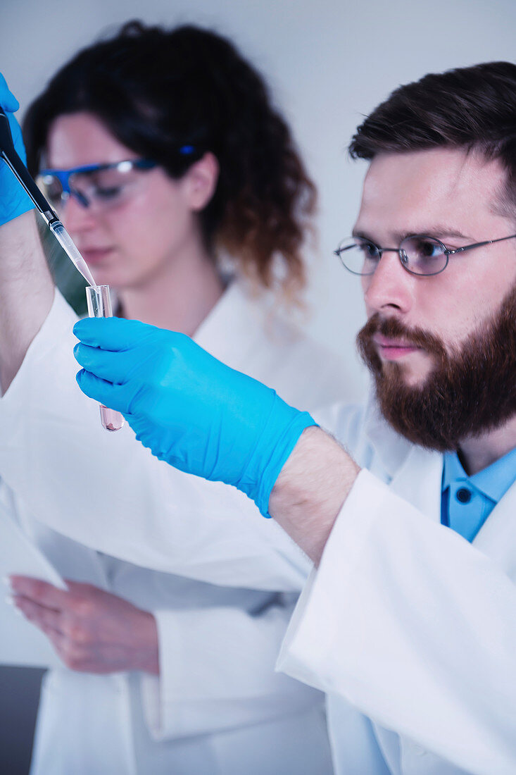 Researcher using micropipette