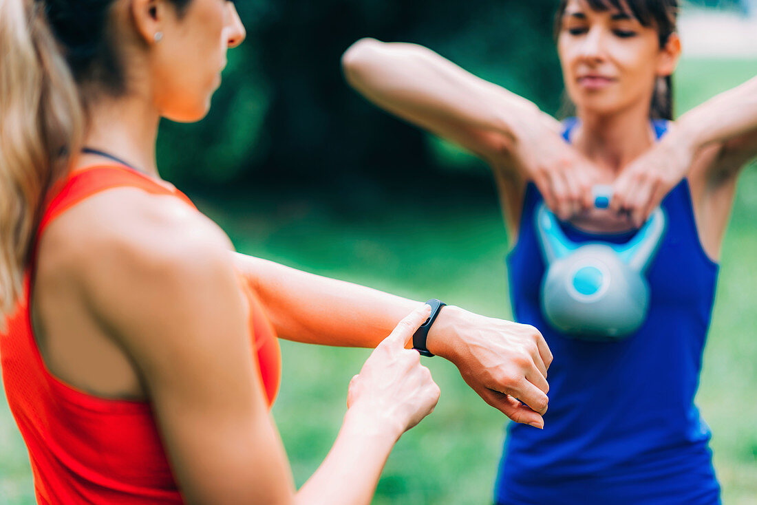 Woman looking at smartwatch during workout