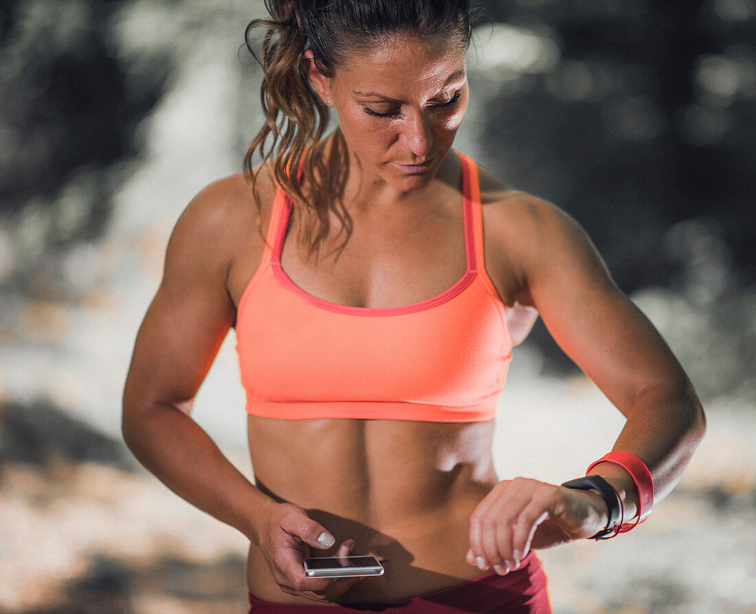 Woman looking at smartwatch during workout