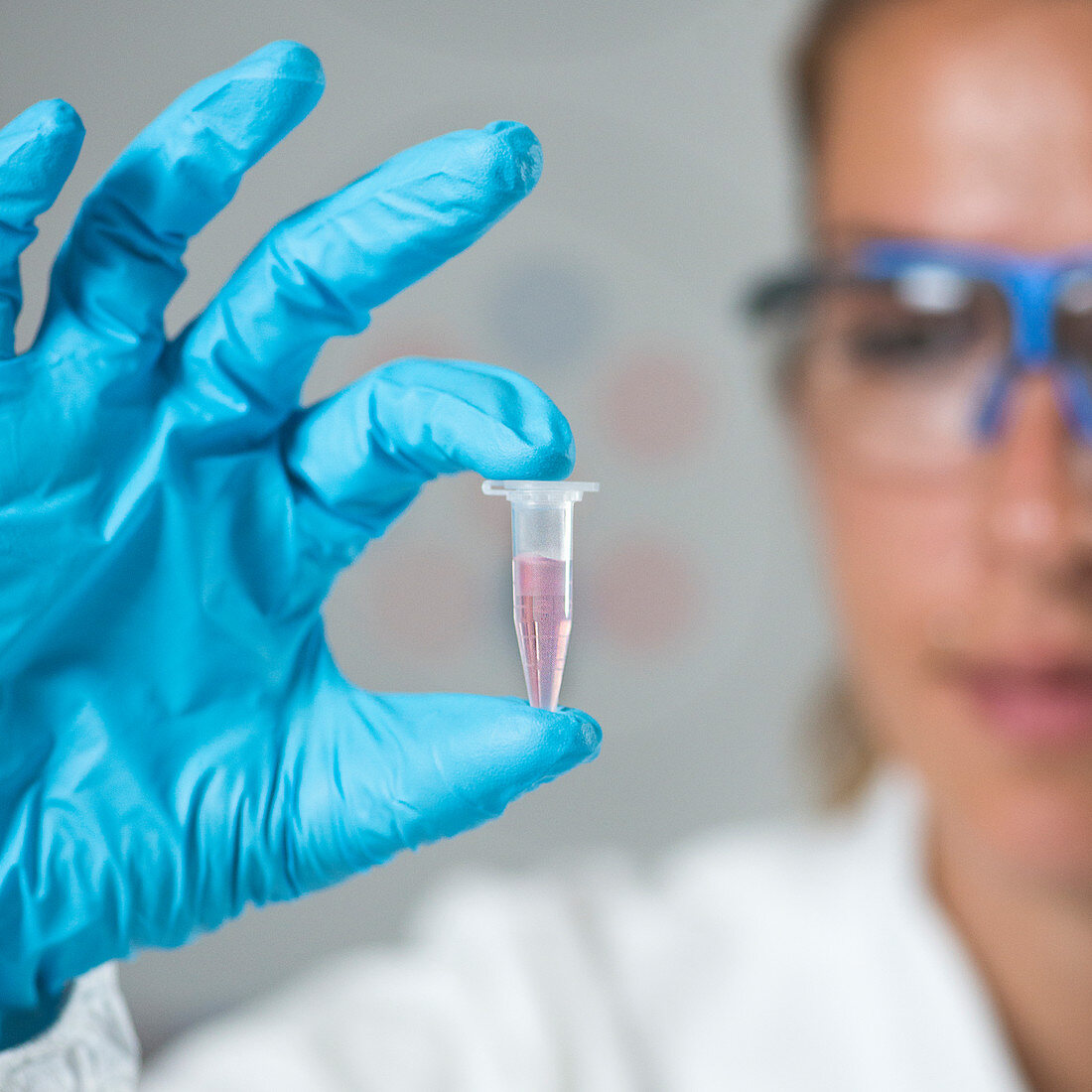 Female researcher holding a sample tube