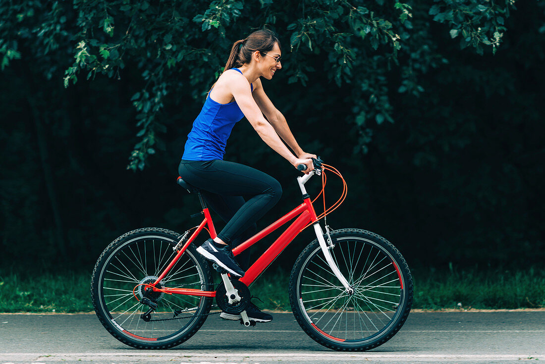 Woman cycling in a park