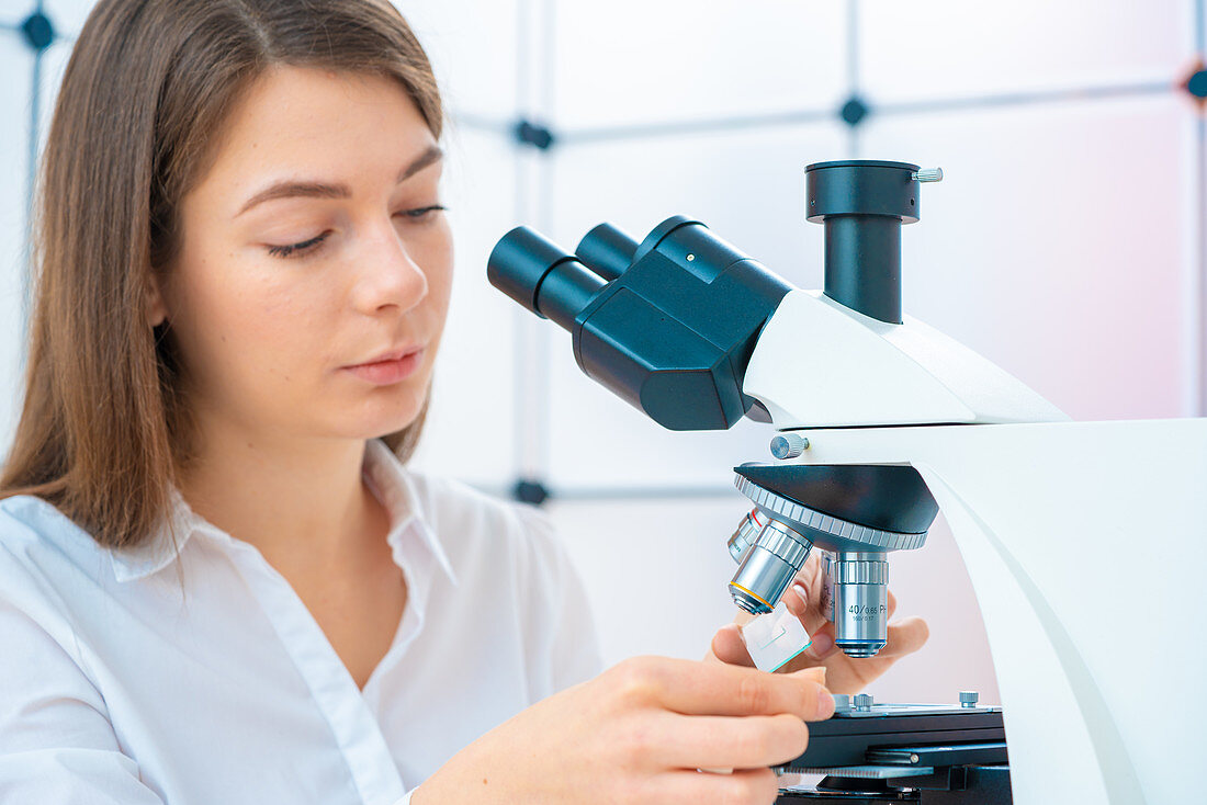 Researcher using microscope