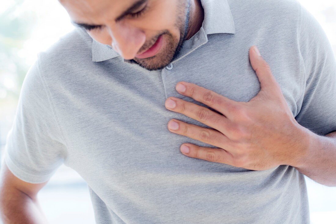 Man touching his chest in pain