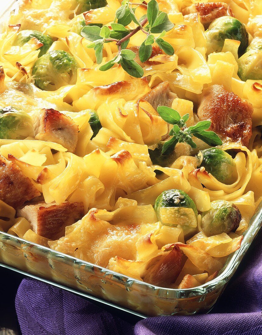 Ribbon pasta bake with diced pork and Brussels sprouts