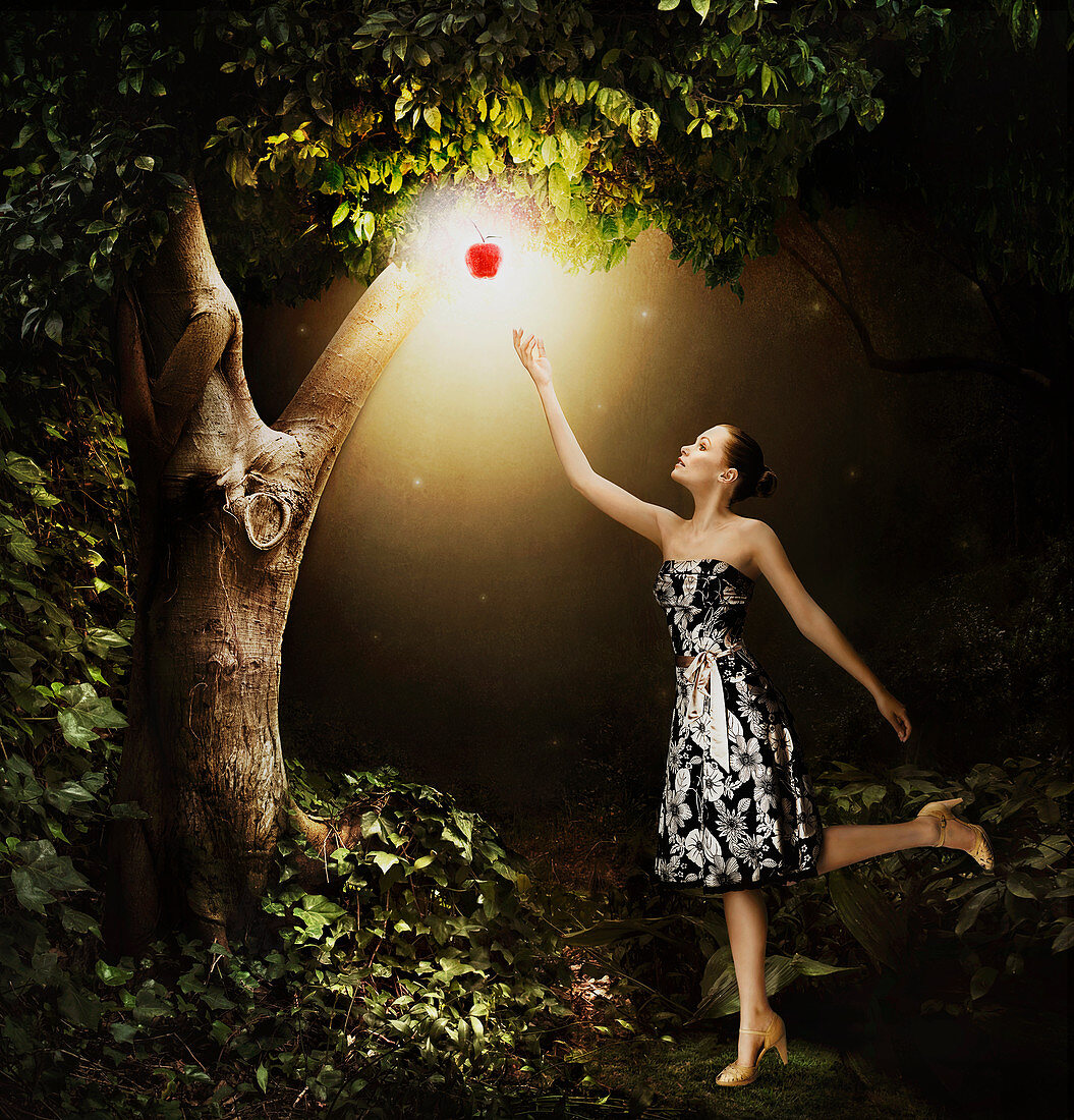 Woman reaching for glowing apple, illustration