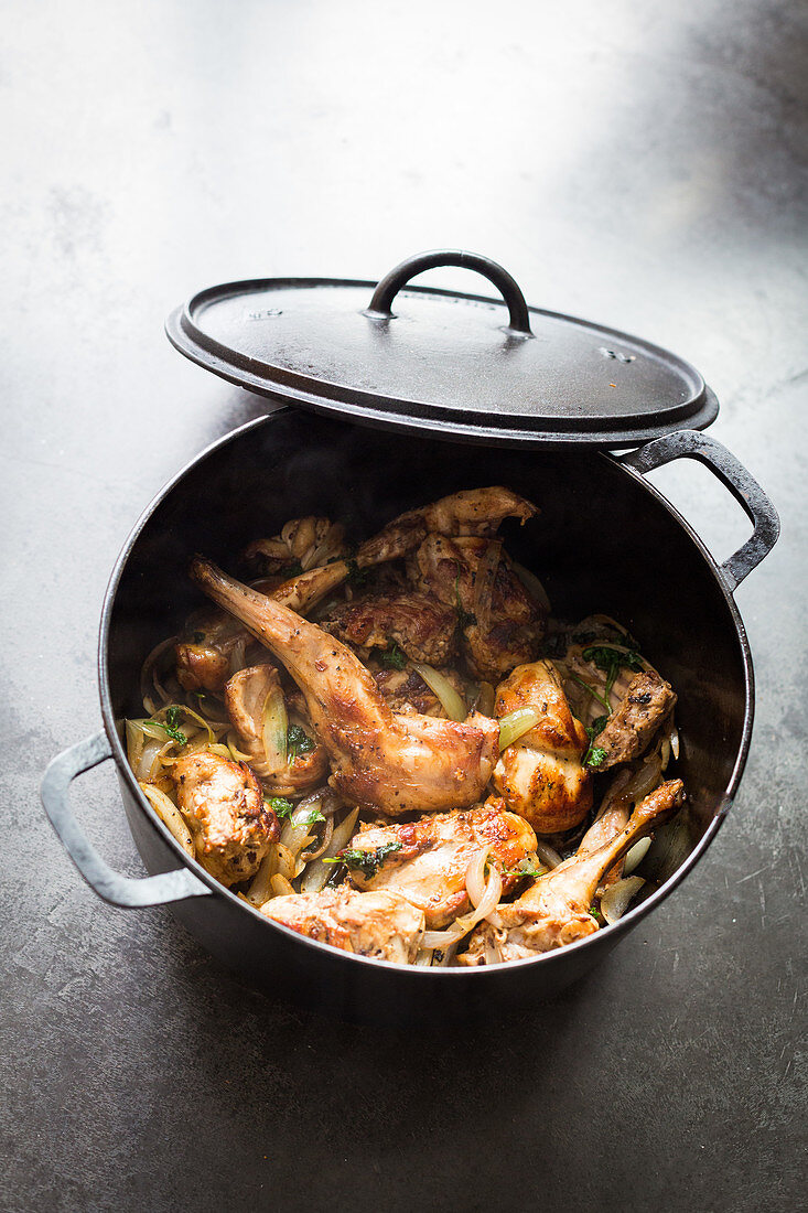 Roasted rabbit cooked in a cast iron casserole