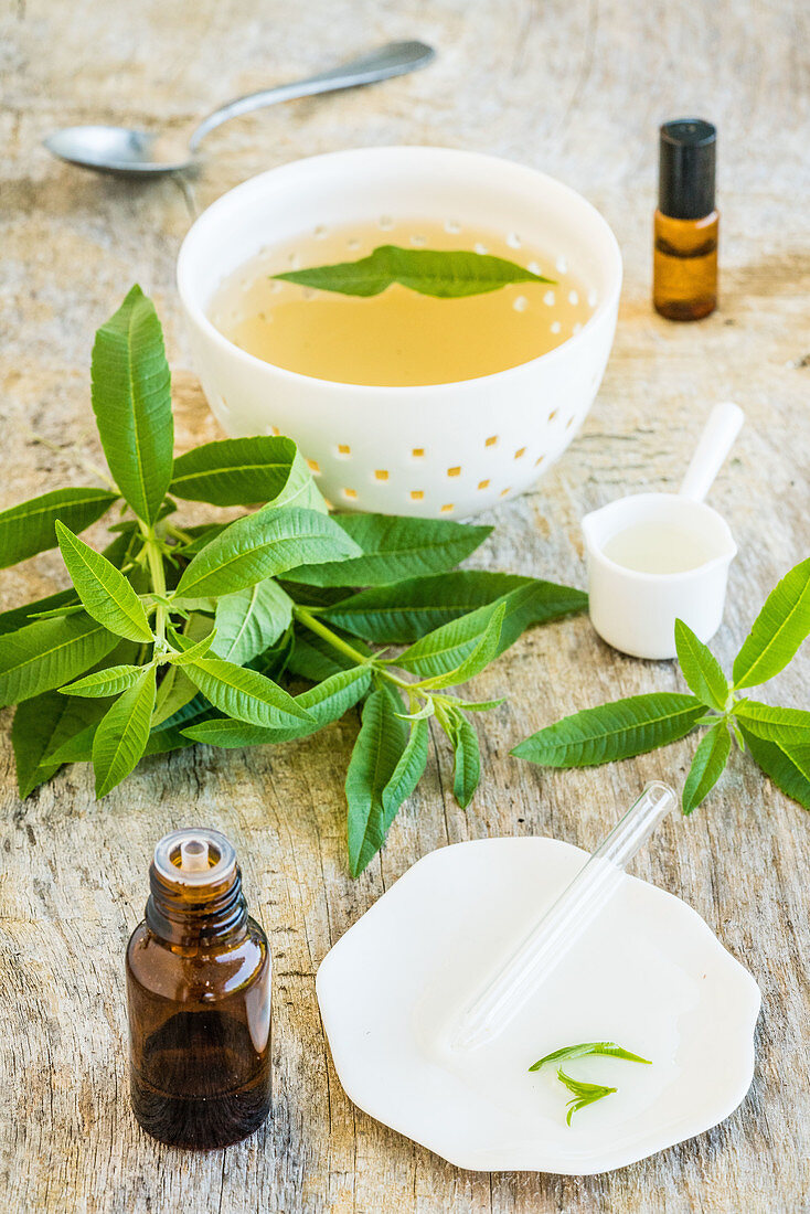 Tea and bottle of lemon verbena essential oil