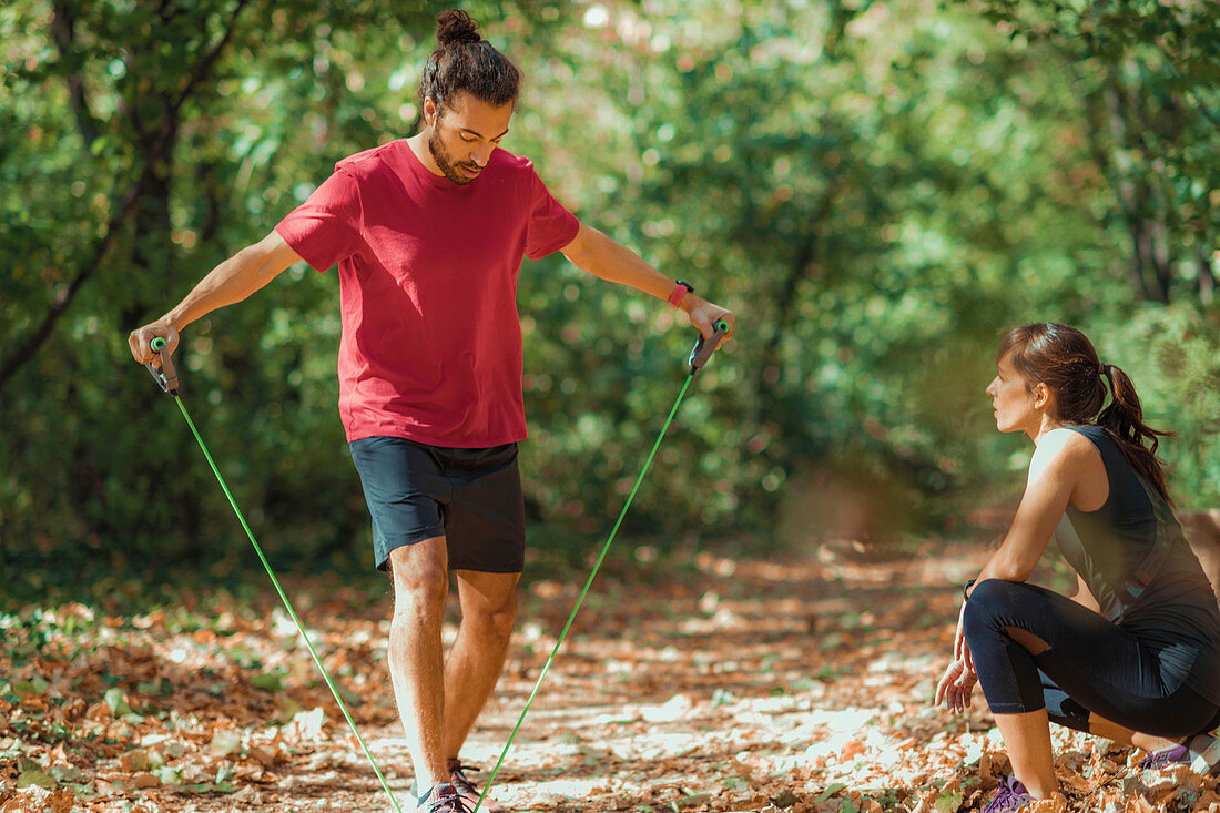 Young couple exercising with elastic resistance bands