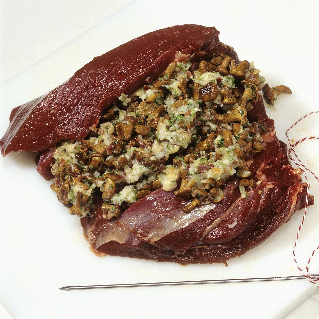 Preparing leg of venison 'Forester's style' (stuffing the meat)