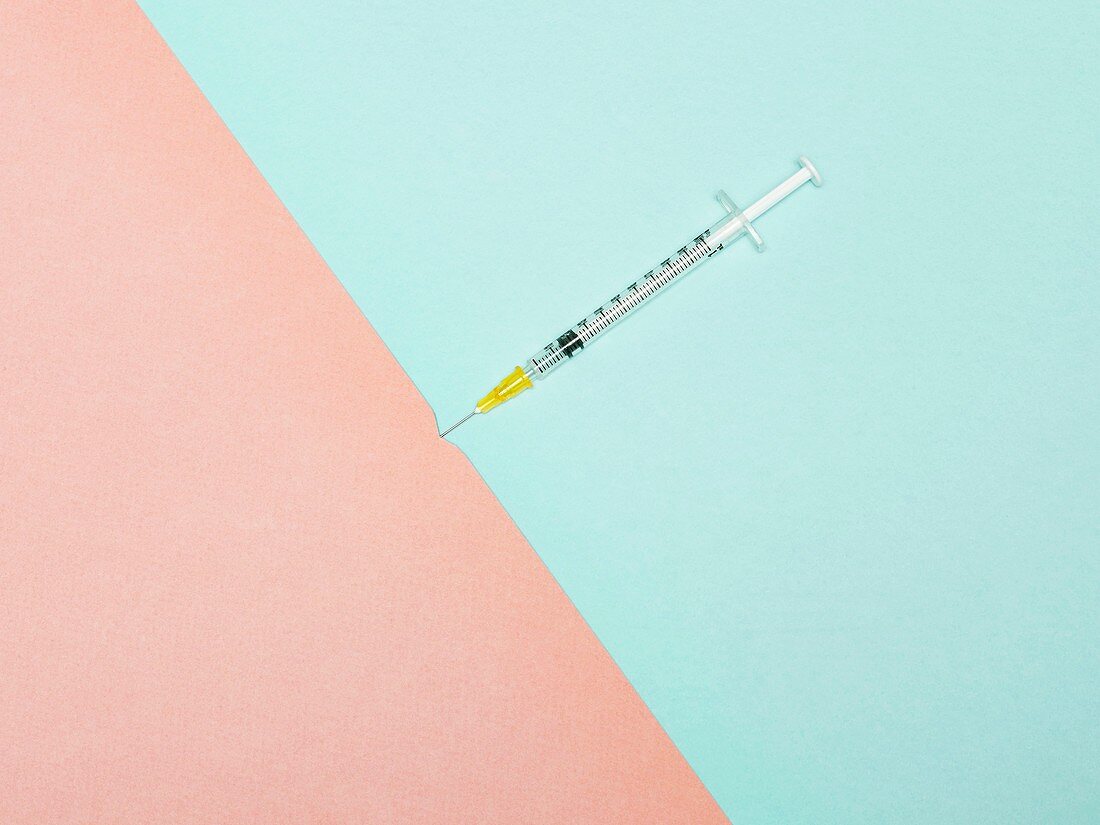 Syringe piercing skin, conceptual image