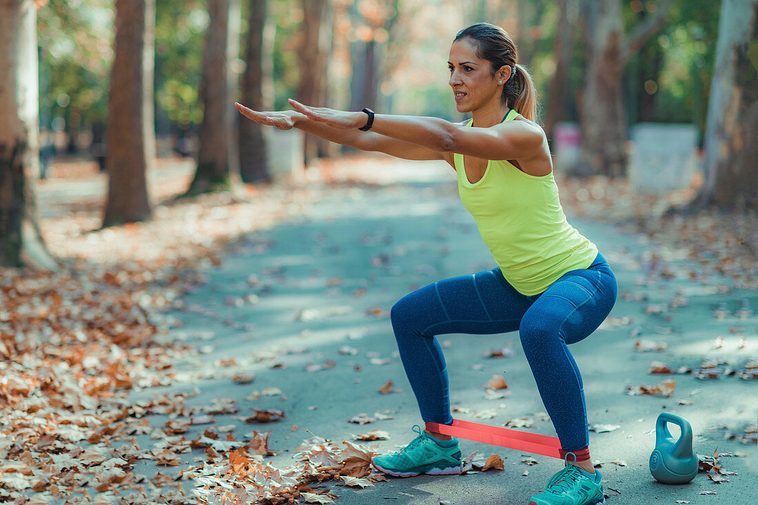 Woman exercising with resistance band outdoors