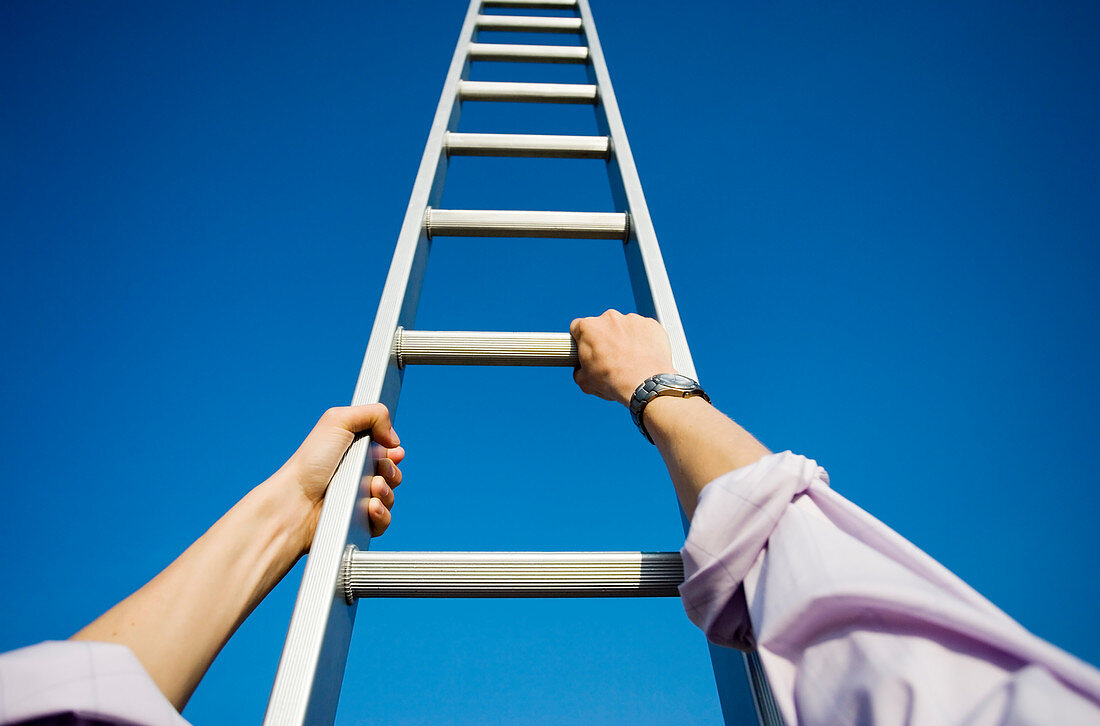 Businessman climbing a ladder