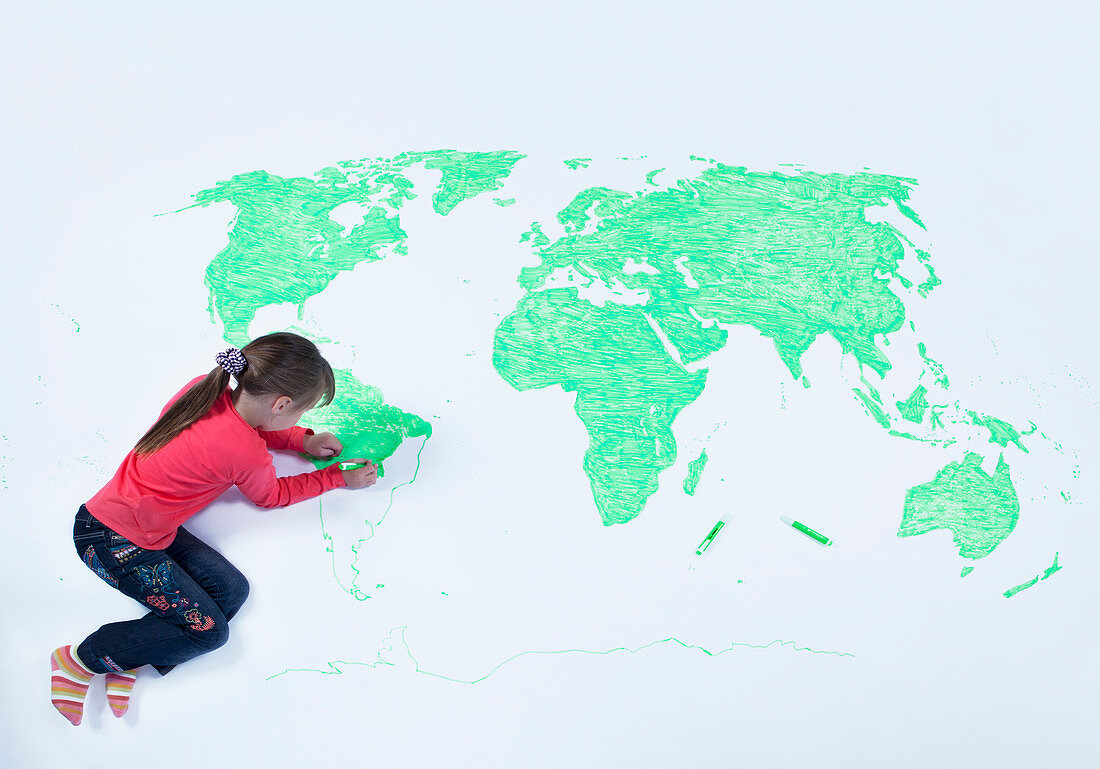 Girl drawing map of the world