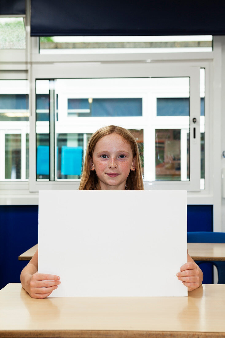 Girl holding up blank placard
