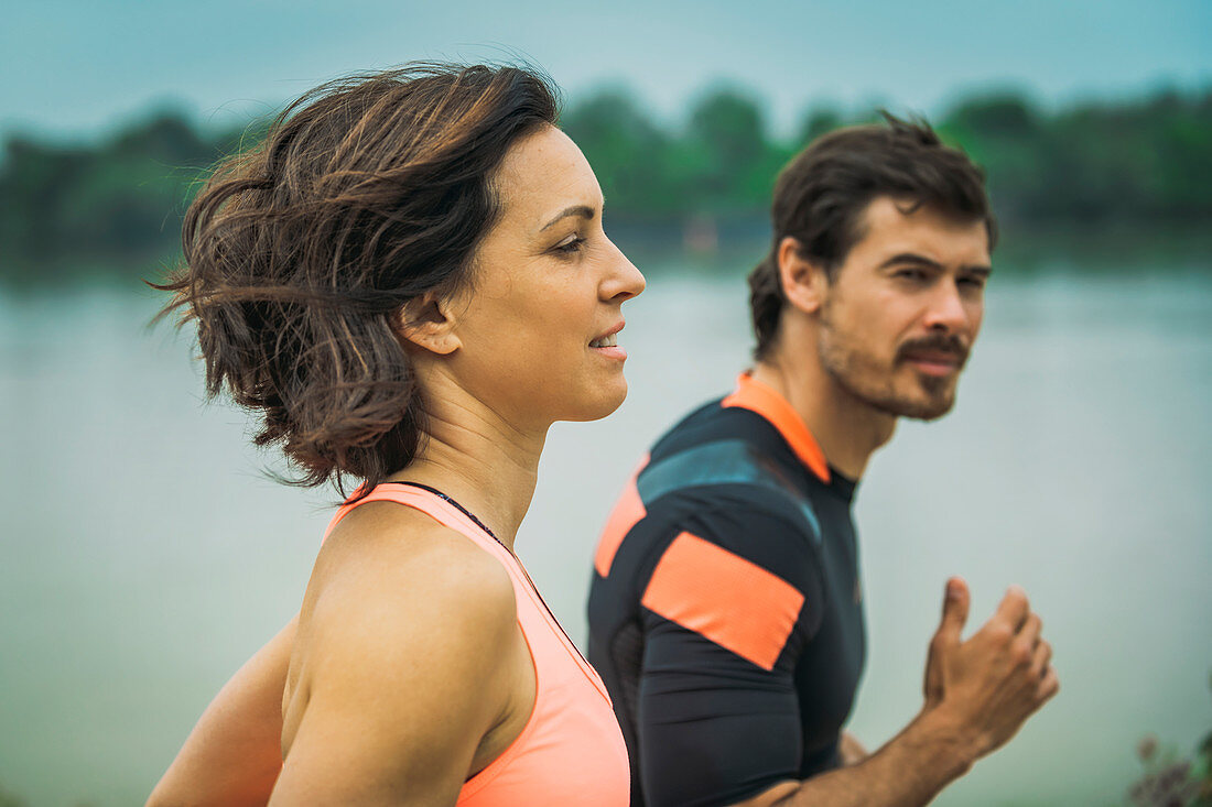 Fit young couple jogging outdoors