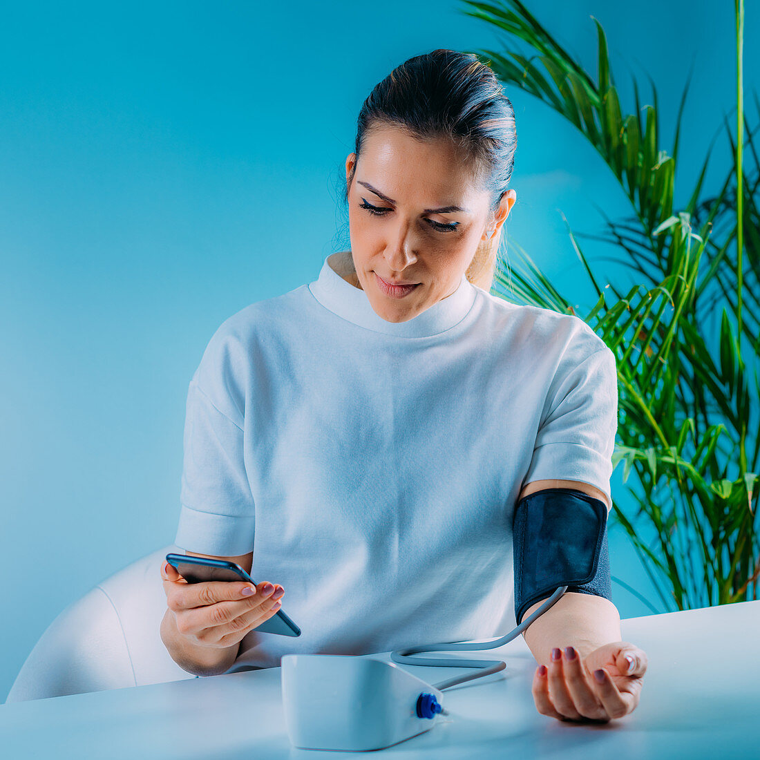 Woman entering blood pressure data in smart phone