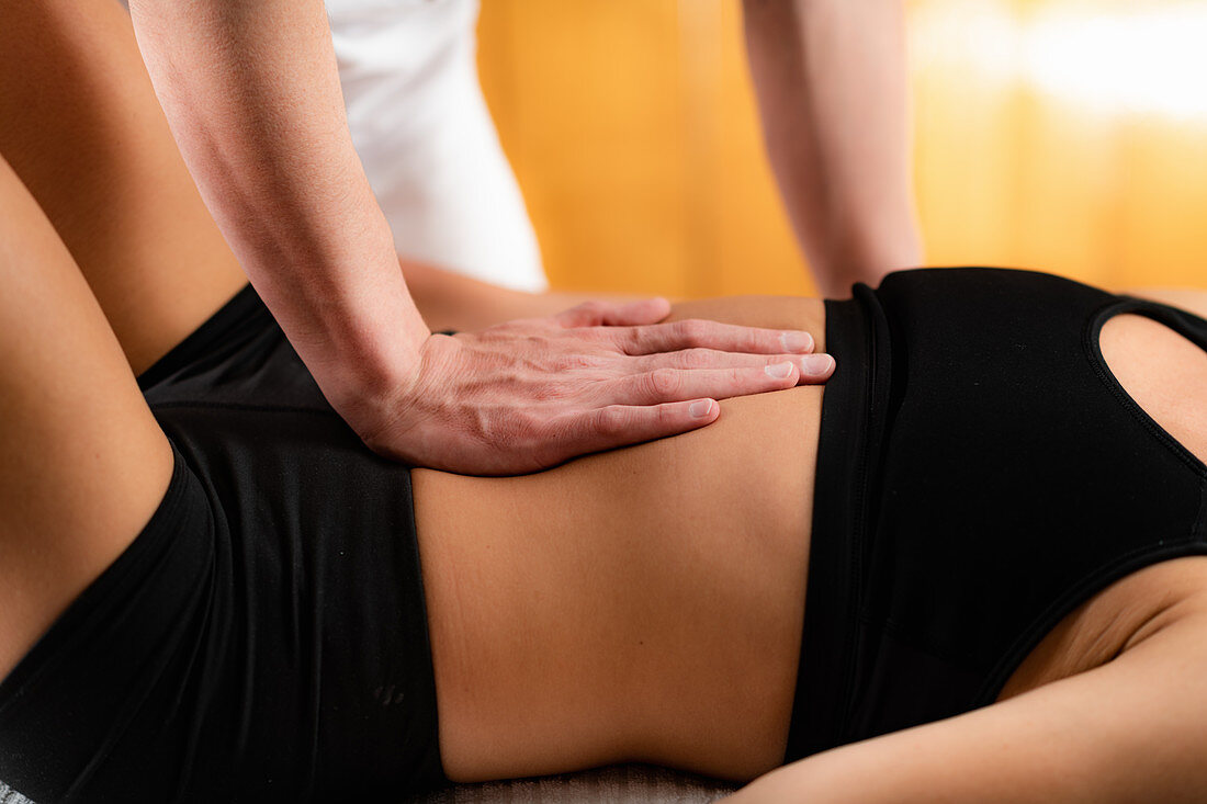 Osteopath working with patient
