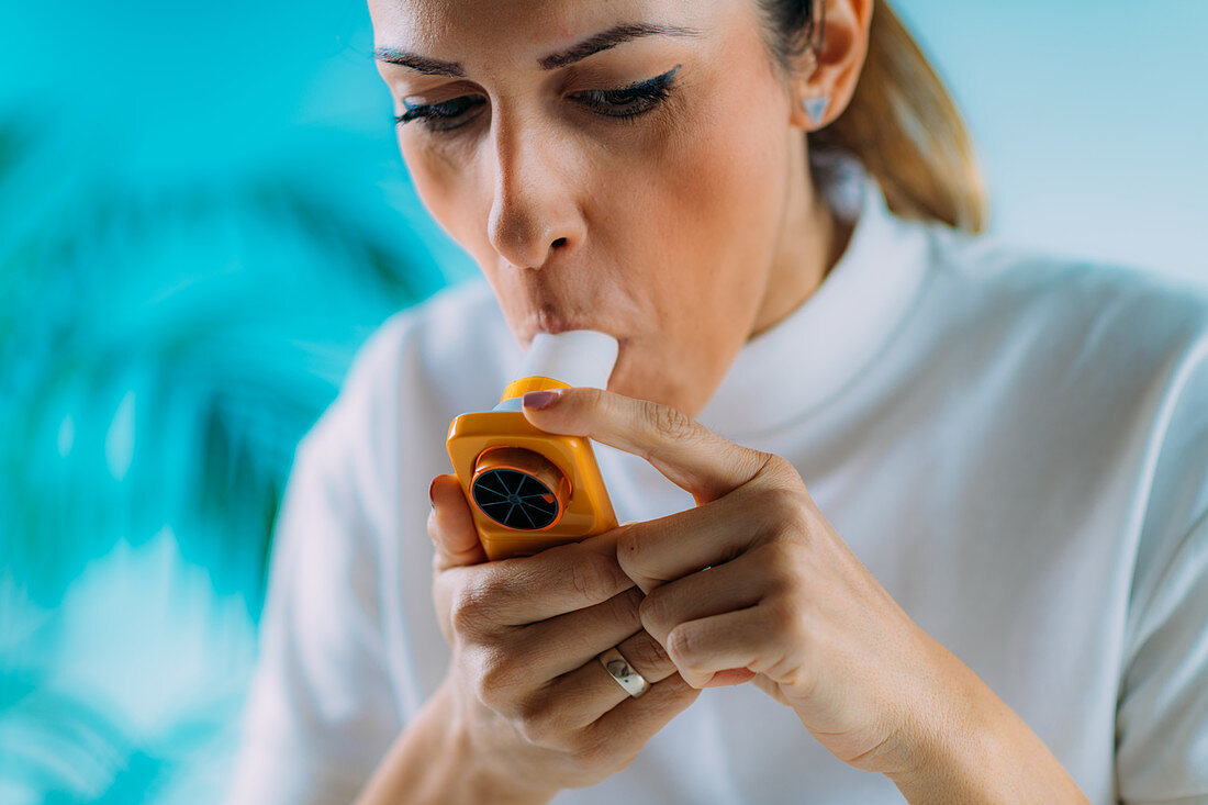Woman using spirometer