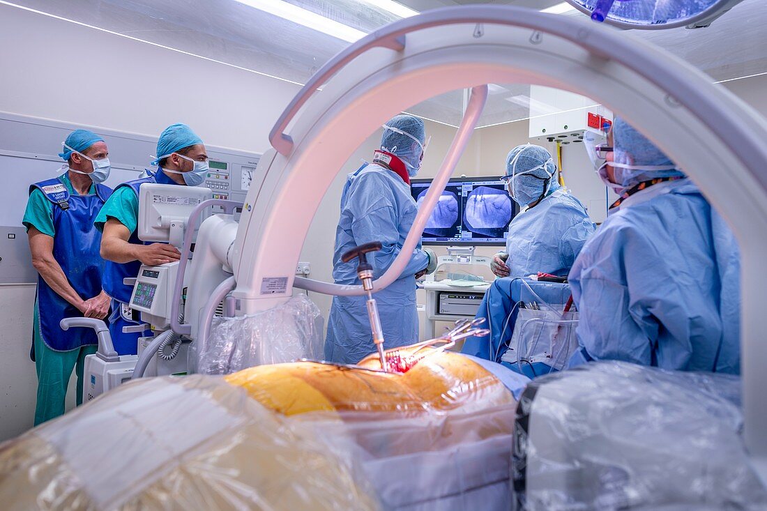 Spinal surgeons conferring during an operation