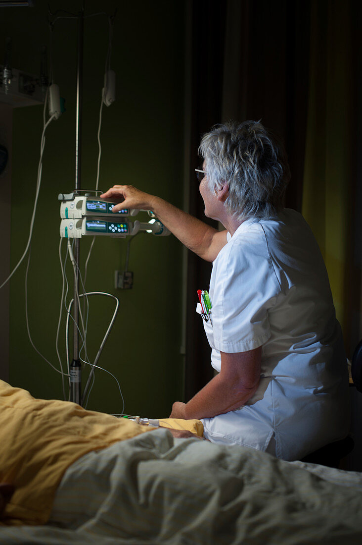 Nurse administering sedative on palliative care ward