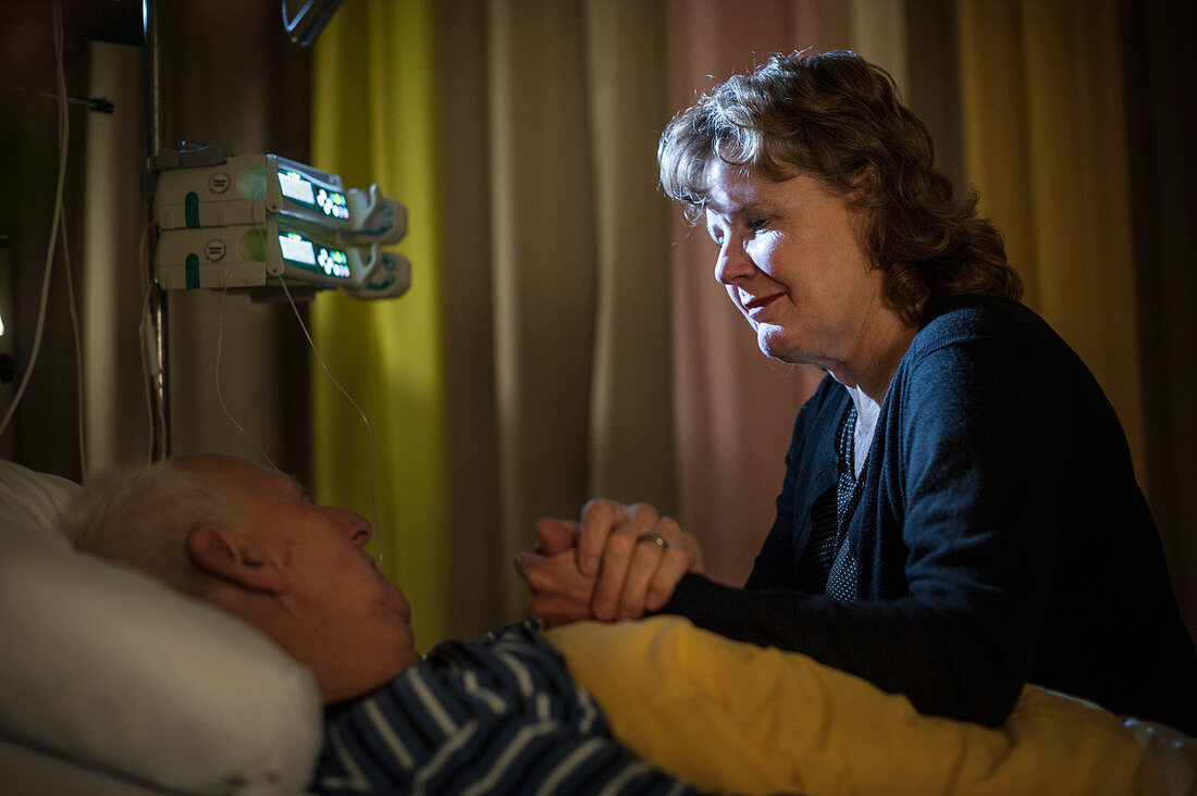 Daughter visiting father on palliative care ward