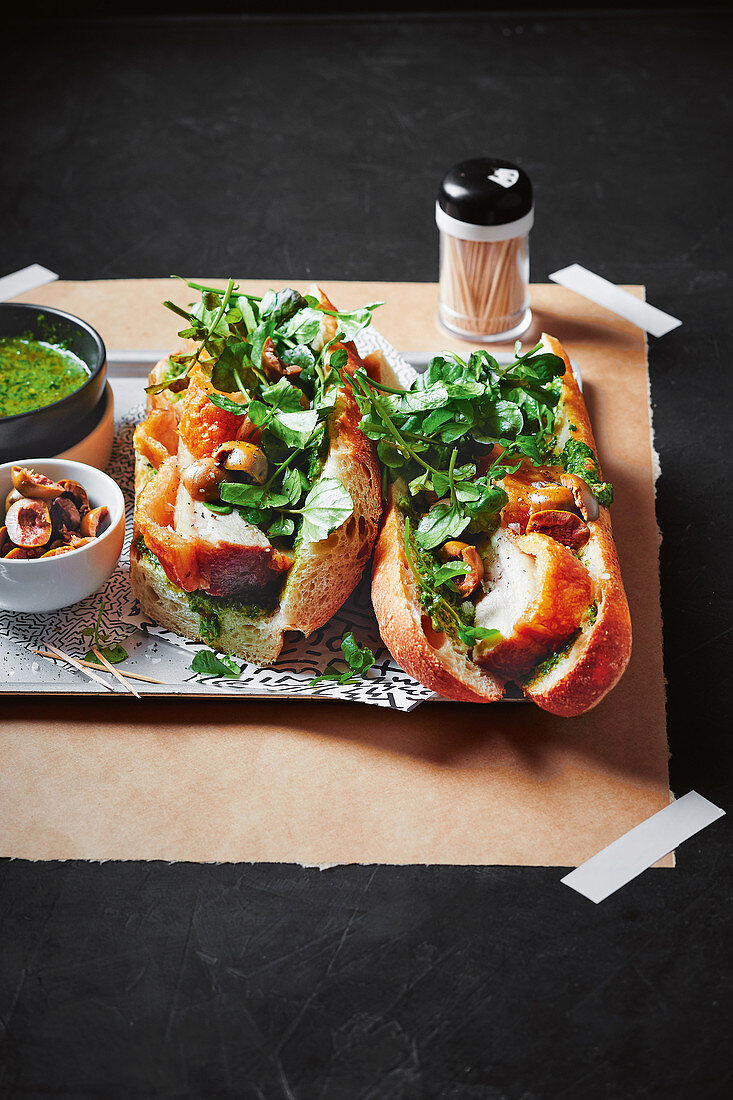 Slow-cooked pork baguette with olives and salsa verde