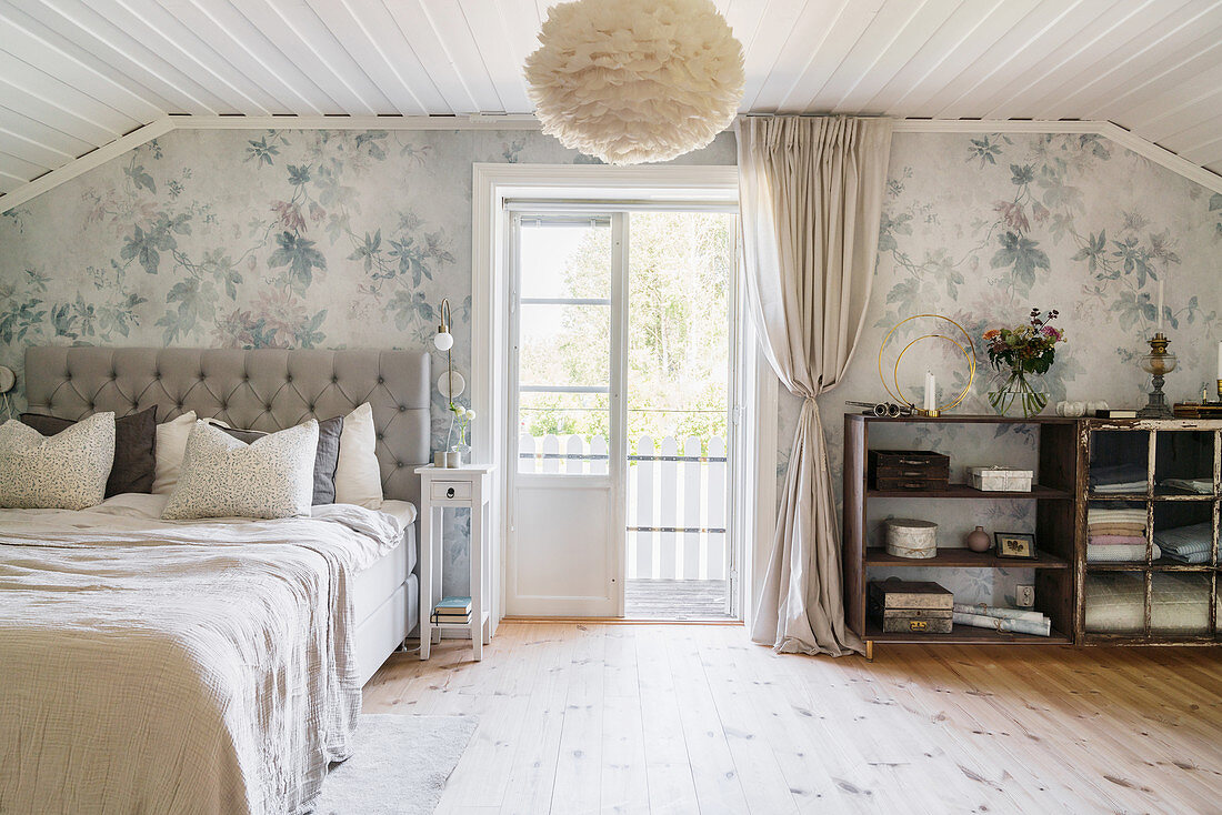 Vintage-style bedroom with sloping ceiling and balcony